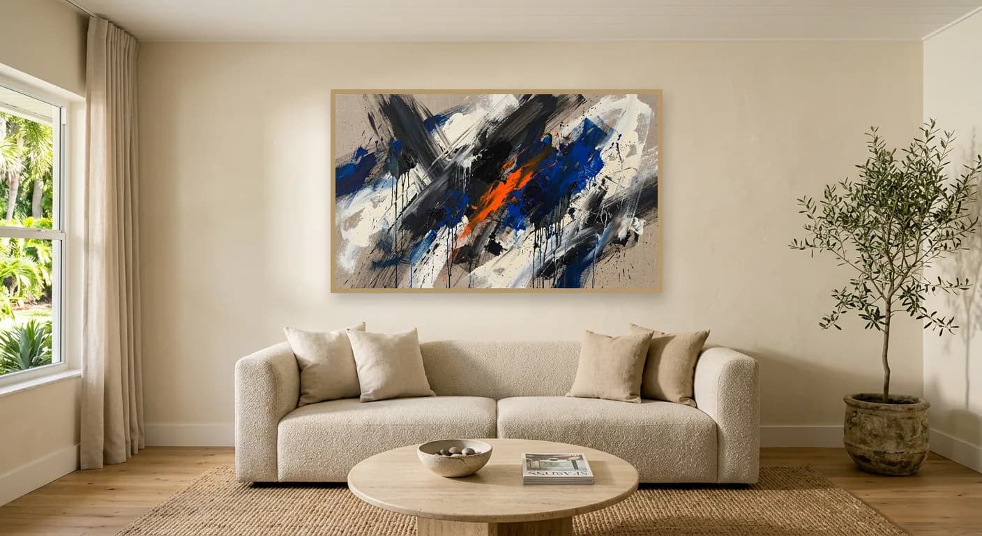 The same living room with a dynamic gestural painting in black, cobalt and orange above the sofa.